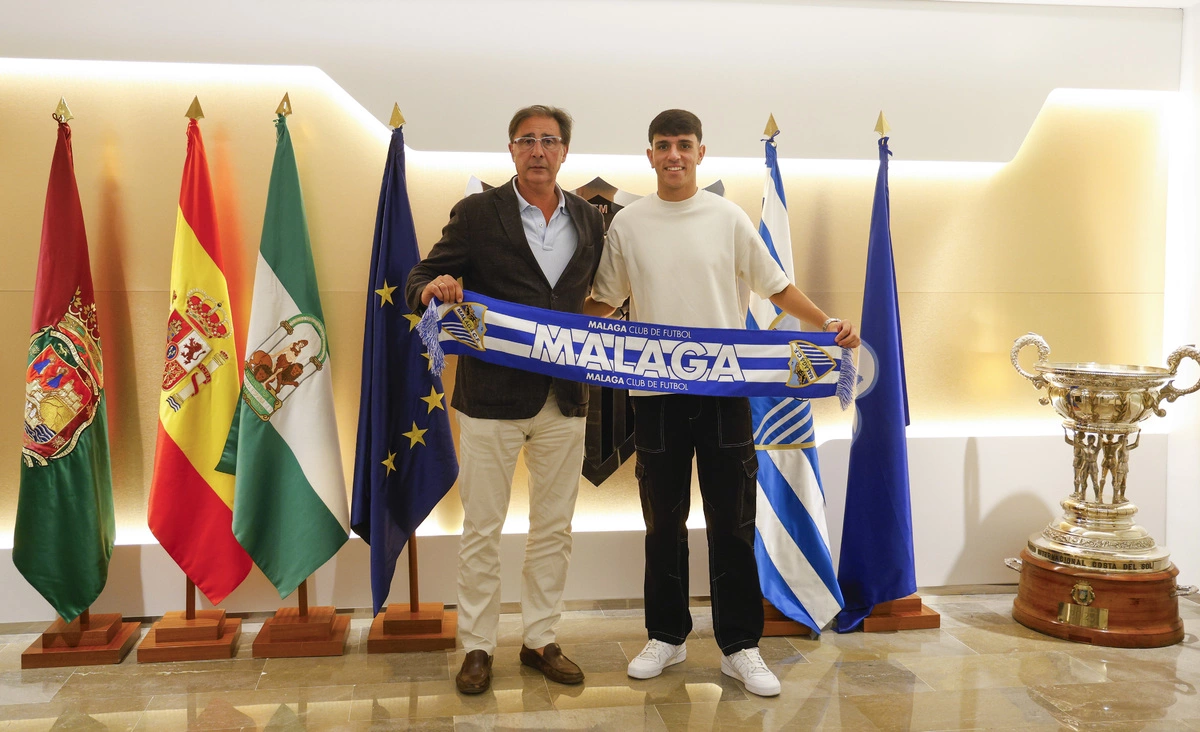 Loren Juarros posa junto a Izan con la bufanda del Málaga (Foto: MCF).